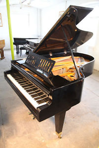 A 1935, Bosendorfer grand piano. Black case, slatted music desk & tapered legs