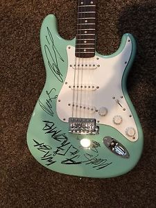 The 1975 Autographed Guitar