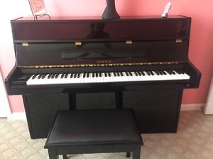 Black lacquer samick up right piano w/ matching bench slightly used 1 owner